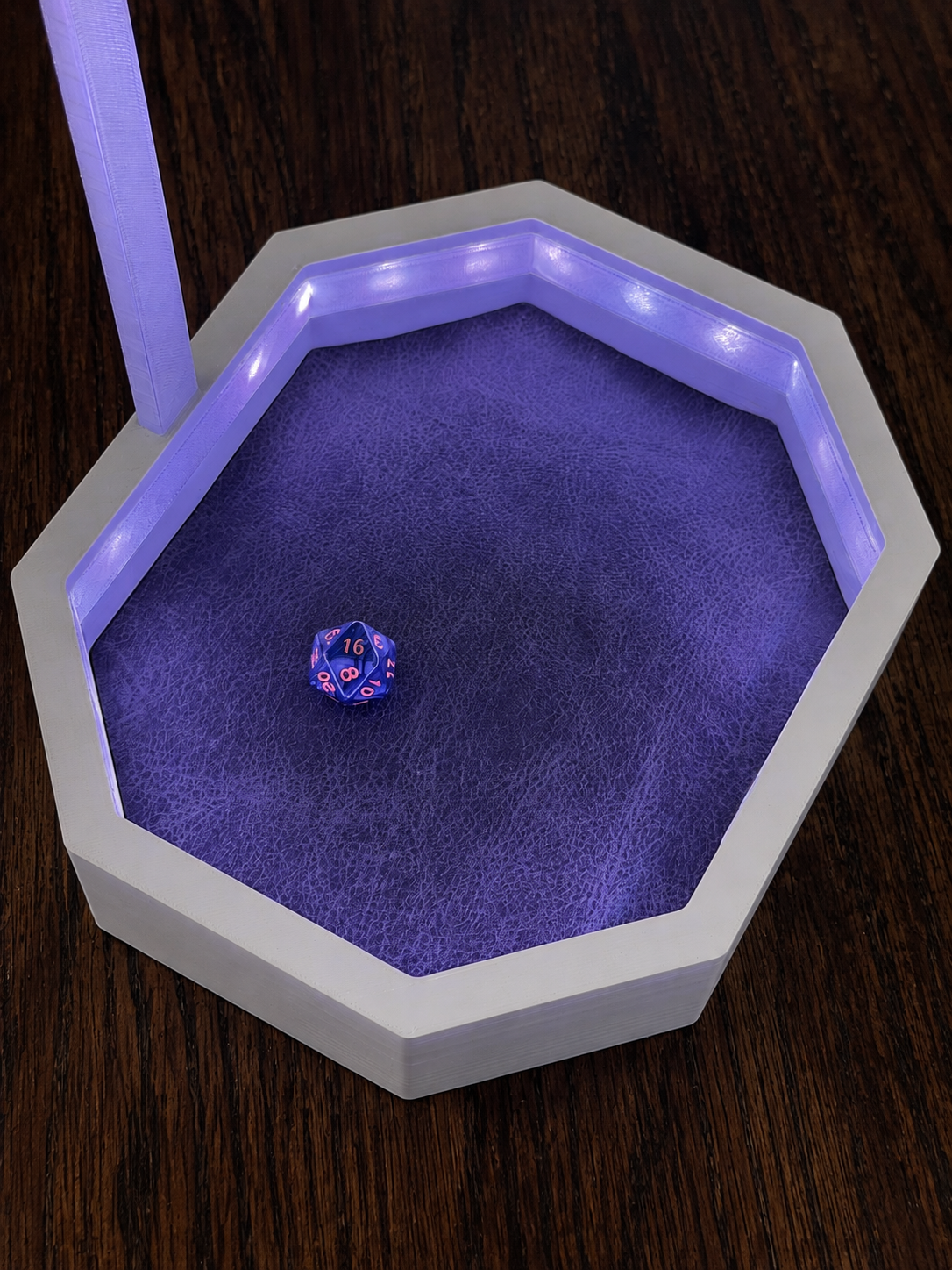 OmniRoll prototype dice tray illuminated with purple LEDs